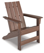 Brown Adirondack chair with slatted back, armrests, and sturdy wooden frame.