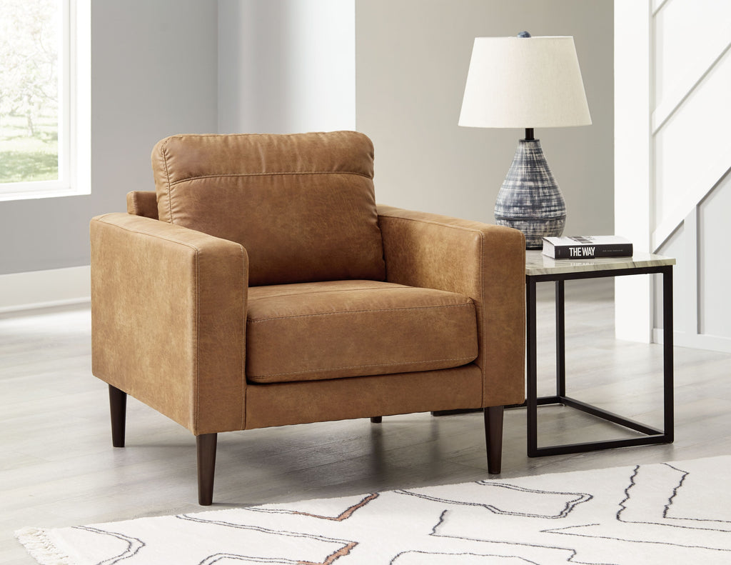 Caramel-brown upholstered accent chair with thick seat cushion and tapered wooden legs