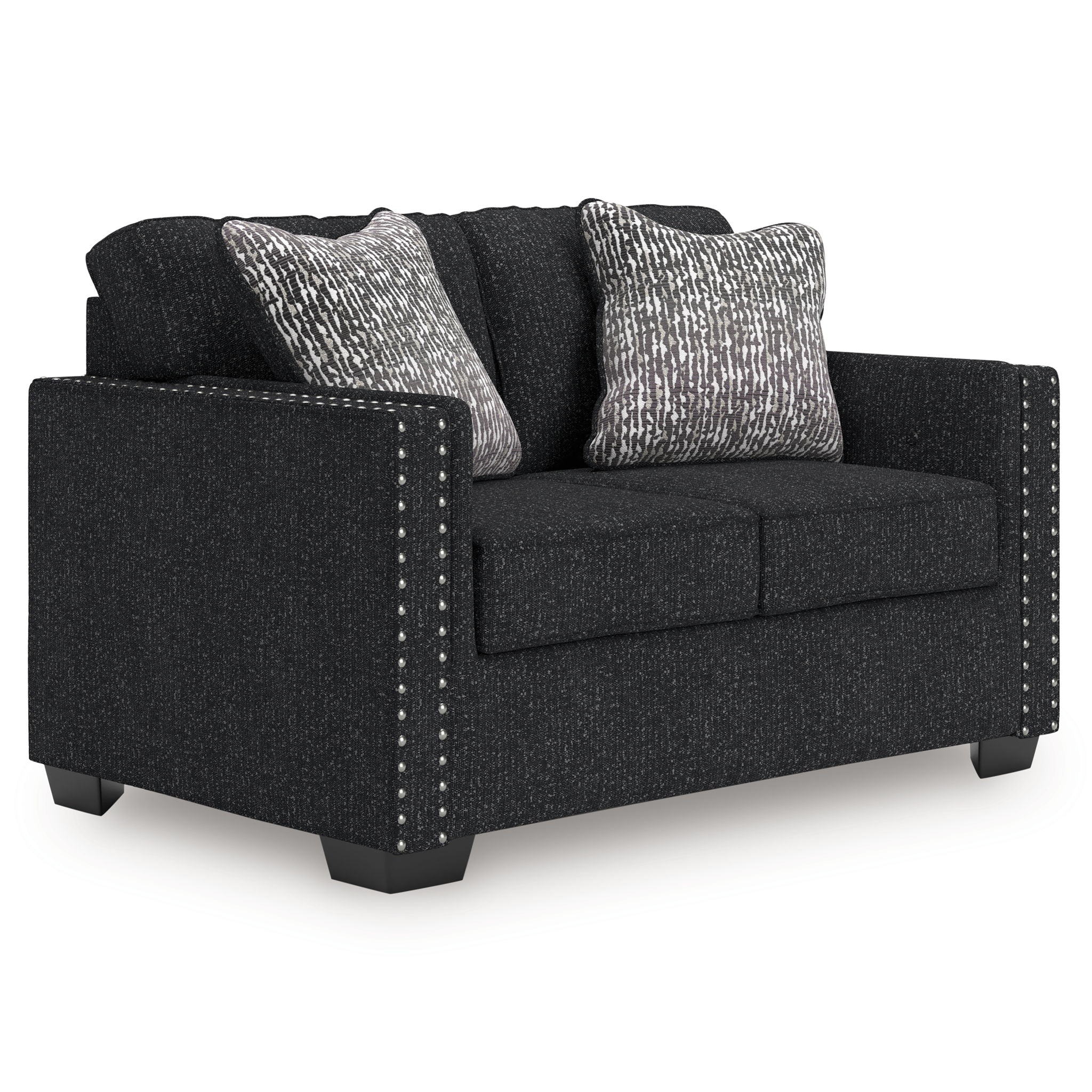 Charcoal loveseat with two patterned throw pillows, dark cushions, and nailhead side trim