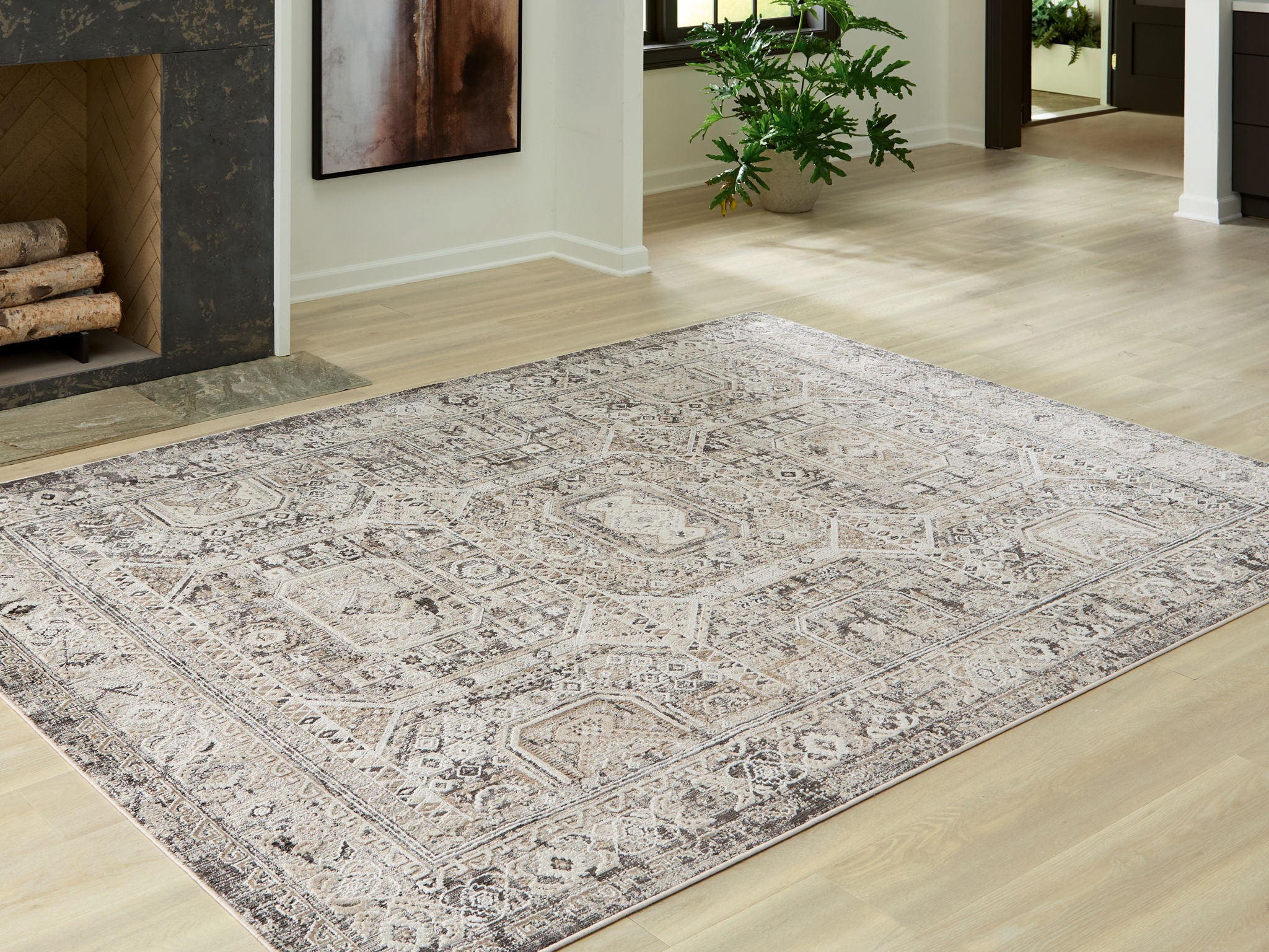 Geometric rug with distressed medallion pattern in light gray on off-white field