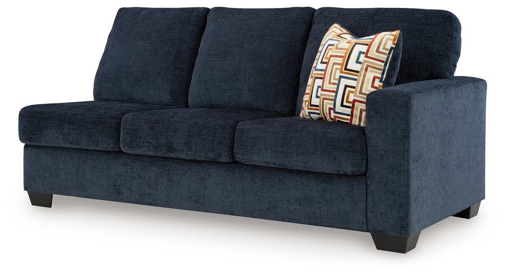 Ink blue fabric sofa with right-side arm and patterned throw pillow detail
