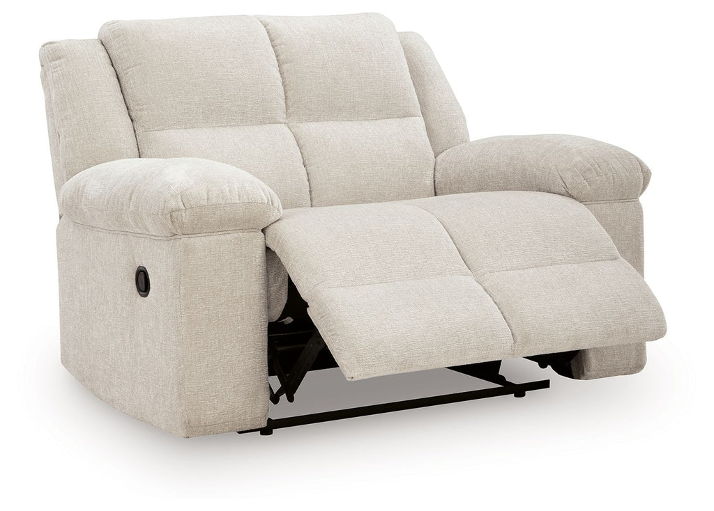 Recliner chair in light beige with extended leg rest and padded arm cushions