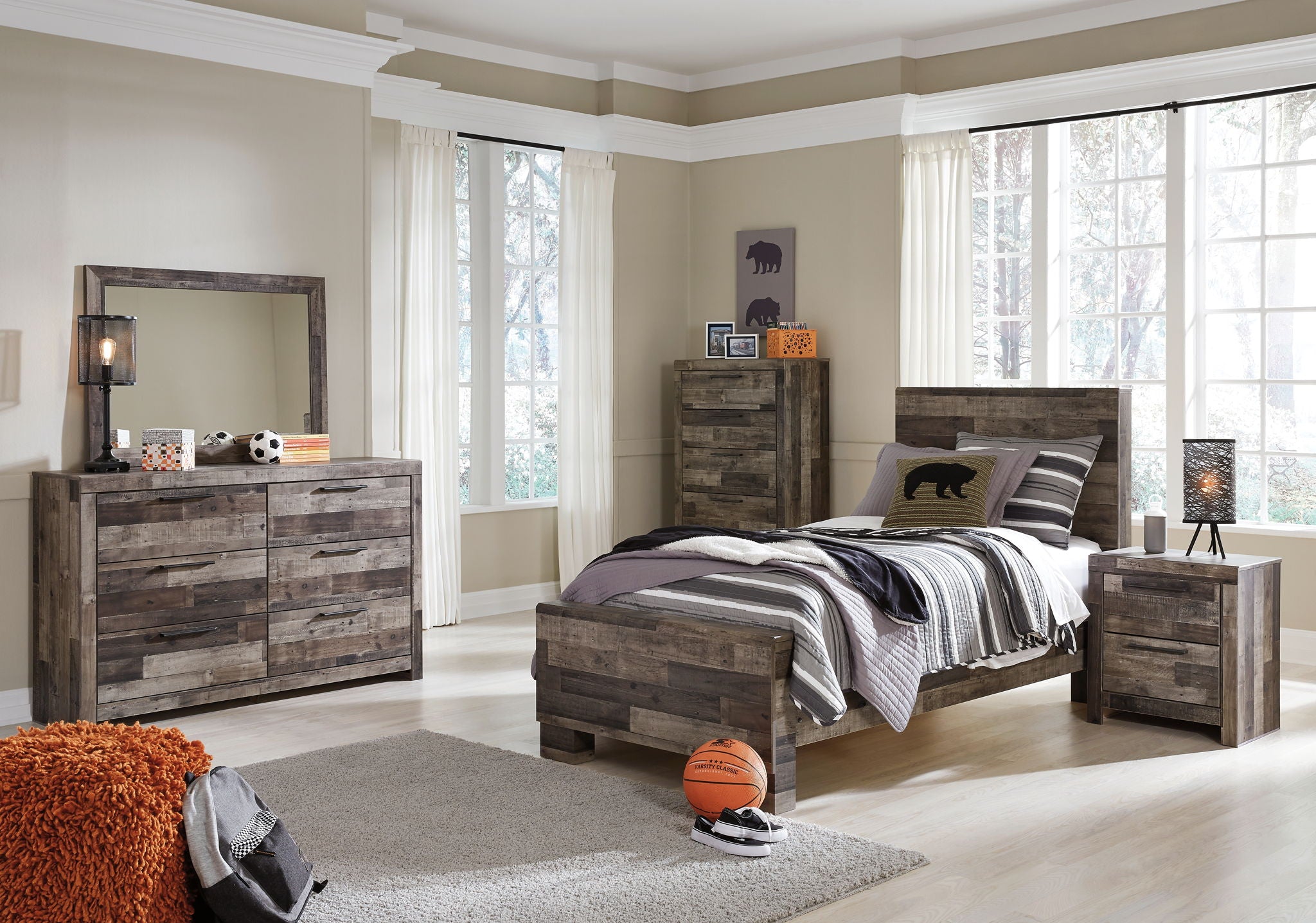 Panel bed with storage drawers, dark gray wood-look finish, angled view with striped bedding