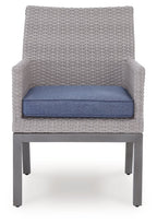 Gray woven armchair with blue cushion, open arms, straight legs