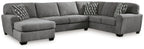 Gray sectional sofa with corner chaise, three cushions, and patterned accent pillows