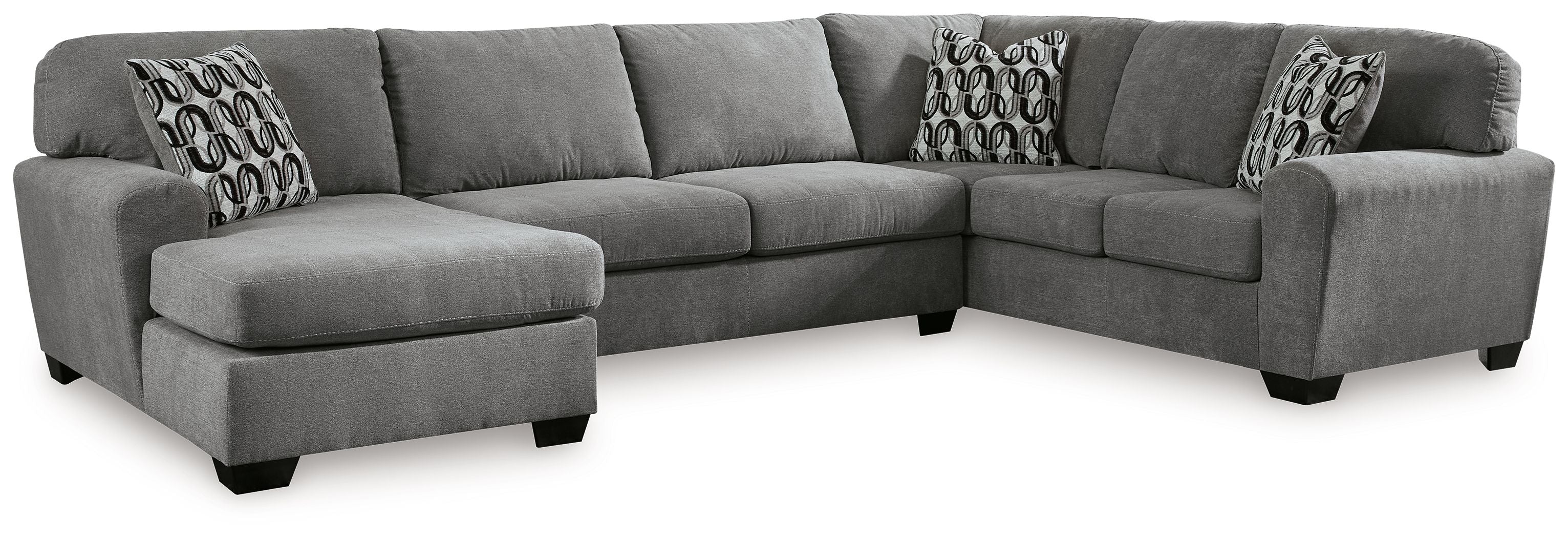 Gray sectional sofa with corner chaise, three cushions, and patterned accent pillows