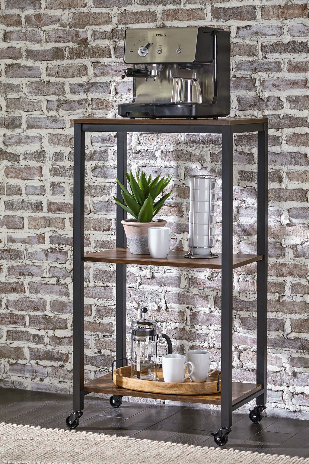 Black metal bar cart with brown shelves, casters, and drinkware on top