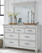 White dresser cabinet with drawers and decorative glass and vase items on top
