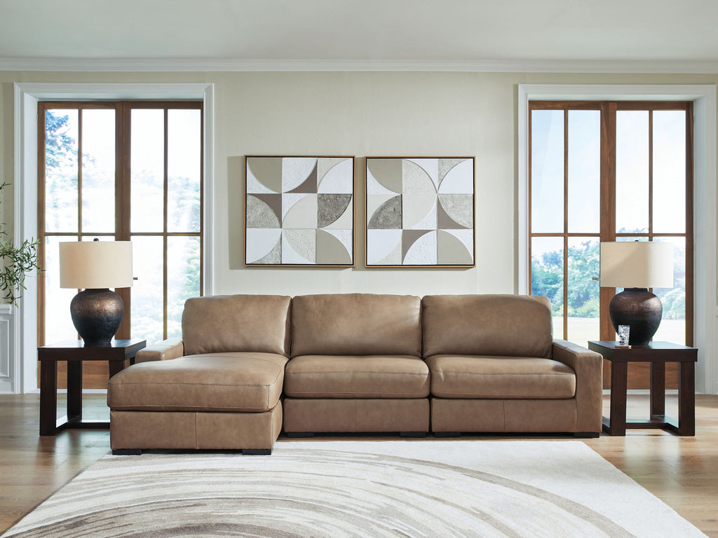 Three-seat sofa with chaise-style ends in taupe upholstery and boxy, padded cushions
