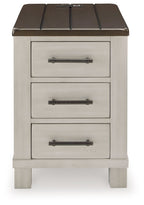Chair side end table close view with dark brown top and three light gray drawers