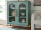 Light green accent cabinet with two arched glass doors and gold pull handles