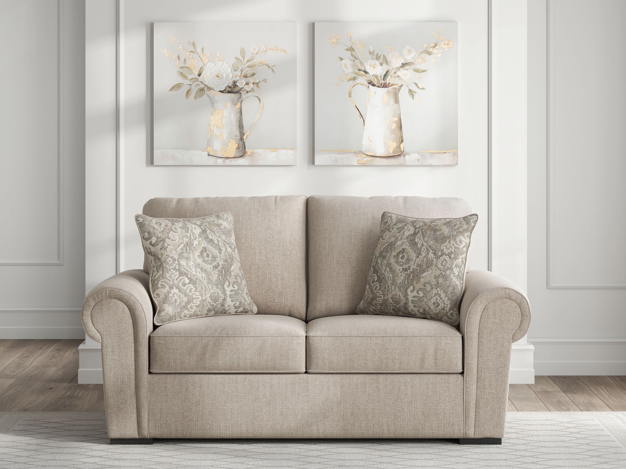 Beige loveseat with rolled arms and patterned throw pillows