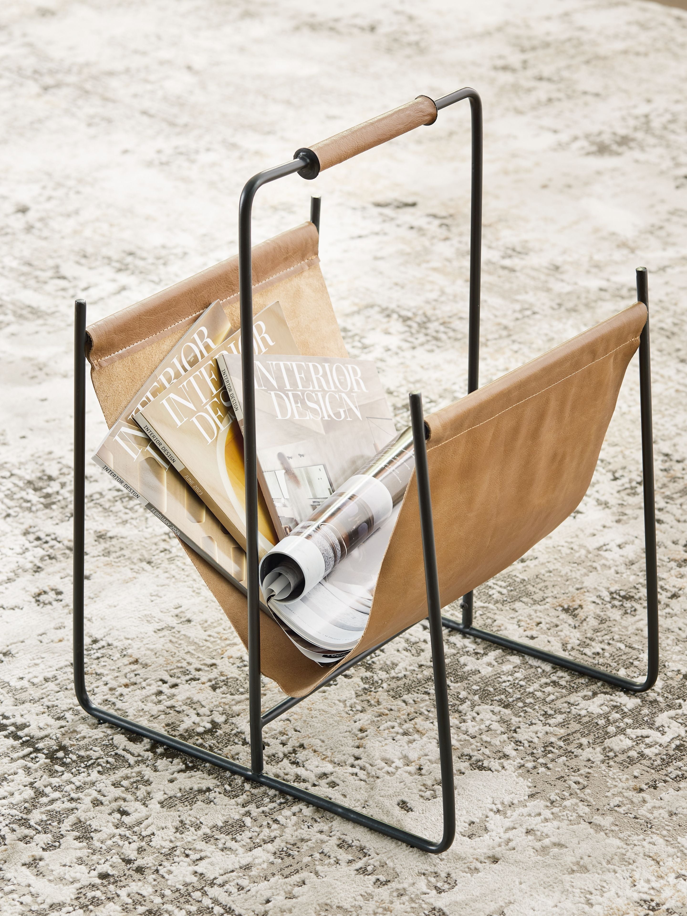 Brown magazine rack with black frame holding magazines and papers