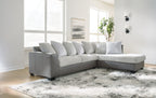 Light gray sectional sofa with chaise corner and striped throw pillows.