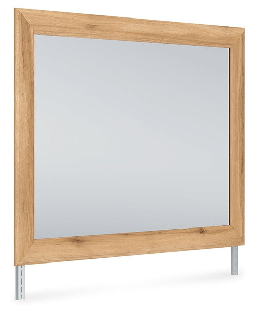 Rectangular bedroom mirror with warm brown wooden frame and small feet