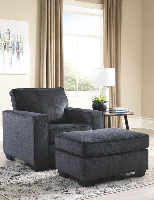 Dark gray fabric armchair with matching ottoman