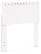 White panel headboard with scalloped top trim and wide rectangular backing