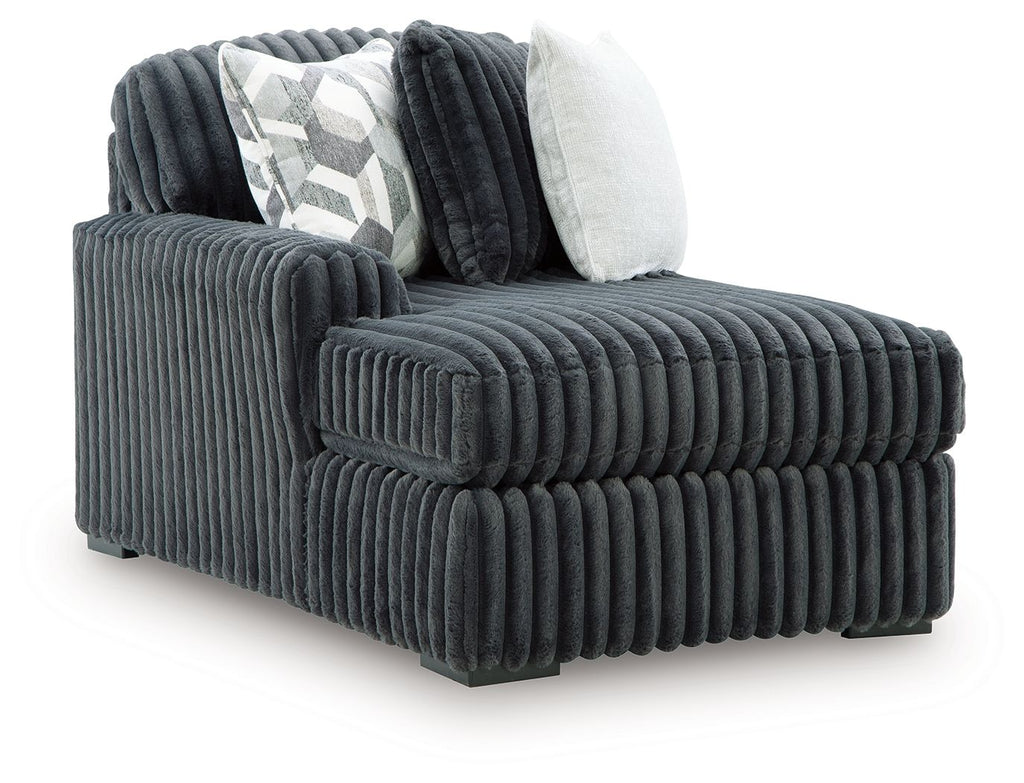 Gunmetal corduroy corner chaise with deep ridged cushions and two throw pillows