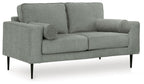 Charcoal loveseat with rolled arms, deep seat, and two round accent pillows