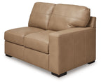 Toffee-brown leather loveseat with track arms, box cushions, and tapered feet