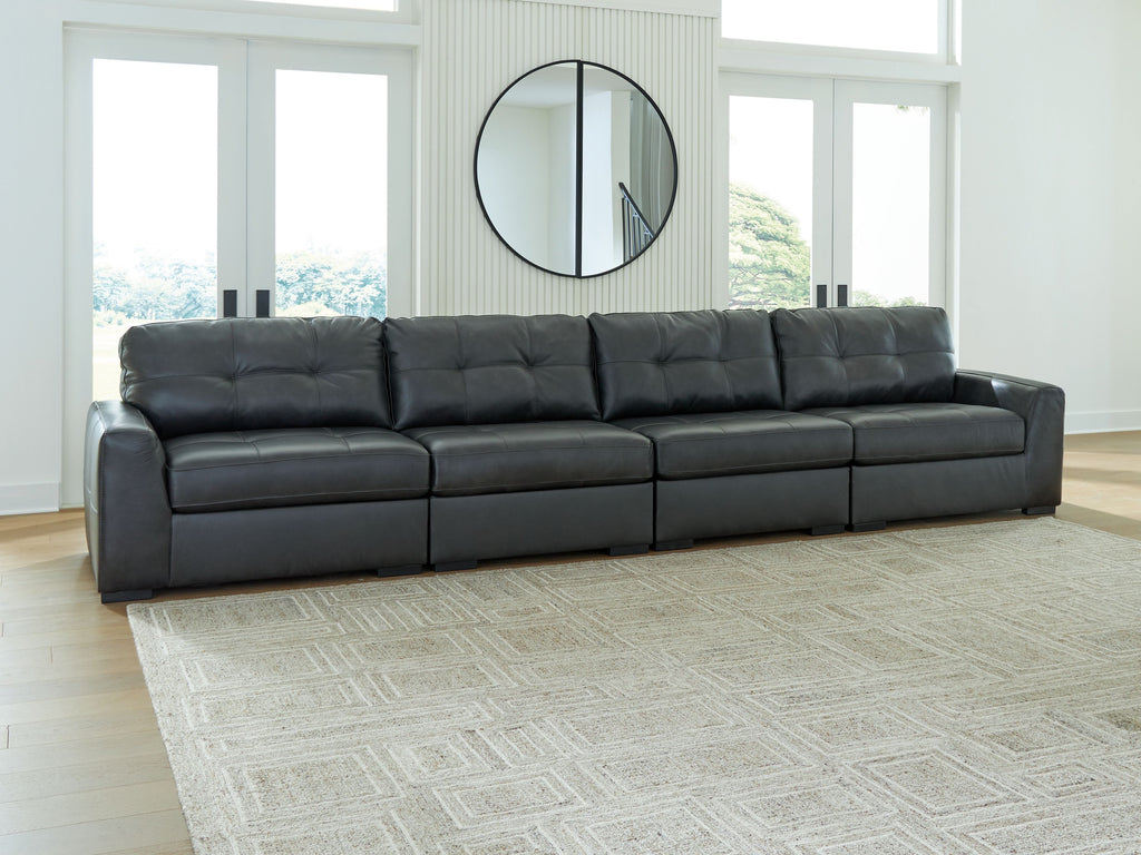 Long sectional sofa with tufted back cushions and dark upholstered seats