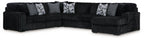 Black corded sectional sofa with chaise and ottoman, striped accent pillows