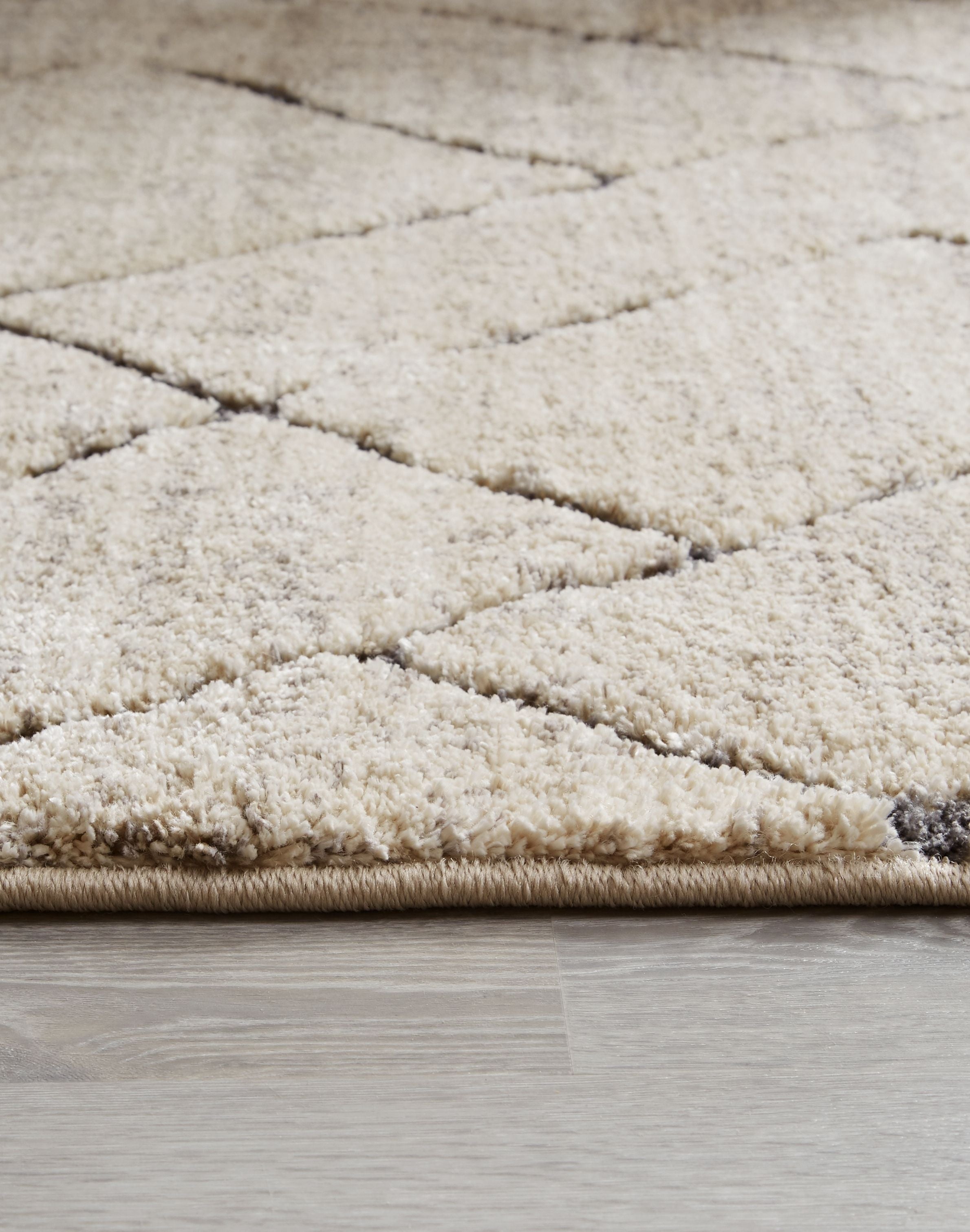 Textured light gray rug with short cut pile and border trim