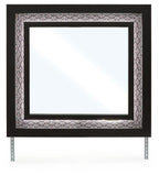 Black bedroom mirror with ornate patterned frame and thick rectangular glass