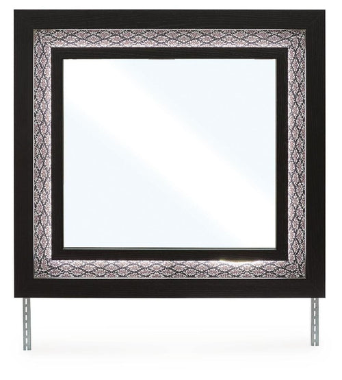 Black bedroom mirror with ornate patterned frame and thick rectangular glass