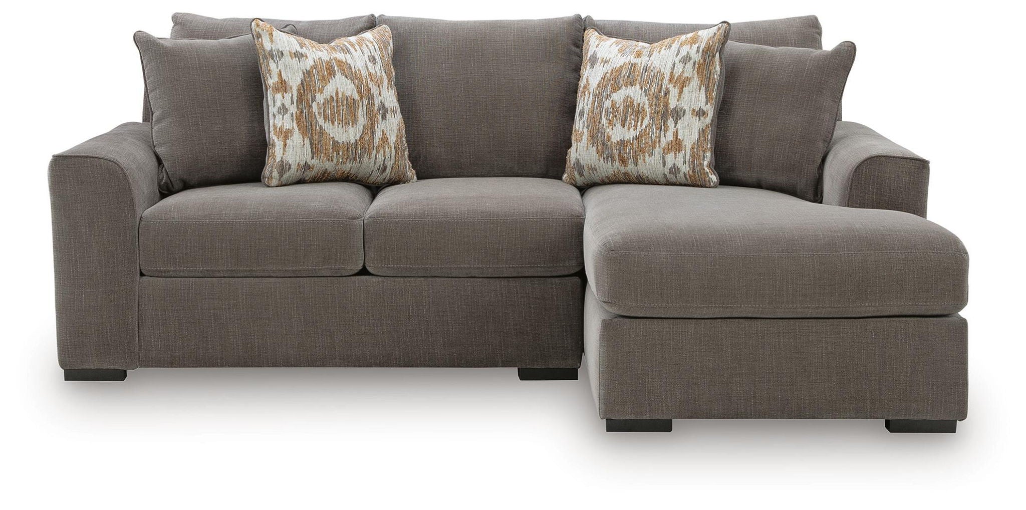 Gray sectional sofa with chaise on right side and two patterned throw pillows