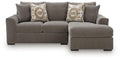 Grey sectional sofa with right-facing chaise and two patterned accent pillows