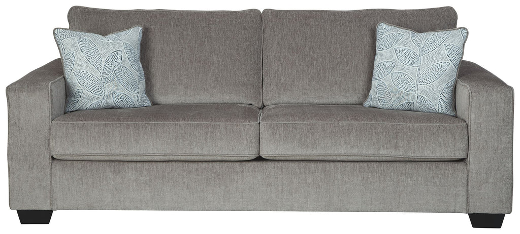 Alloy stationary sofa with square arms, tufted back, and two light patterned throw pillows