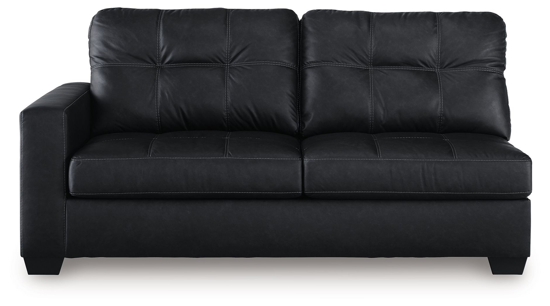 Dark sofa with tufted back, flat seat cushions, and boxy arms