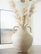 Beige ceramic vase with dried pampas grass stems and two side handles
