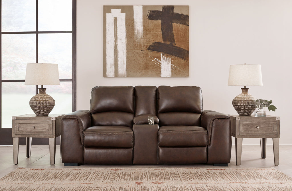 Brown leather loveseat with reclining seats, center console, and padded armrests.