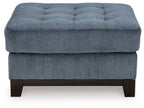 Blue oversized accent ottoman with tufted top and dark wooden legs