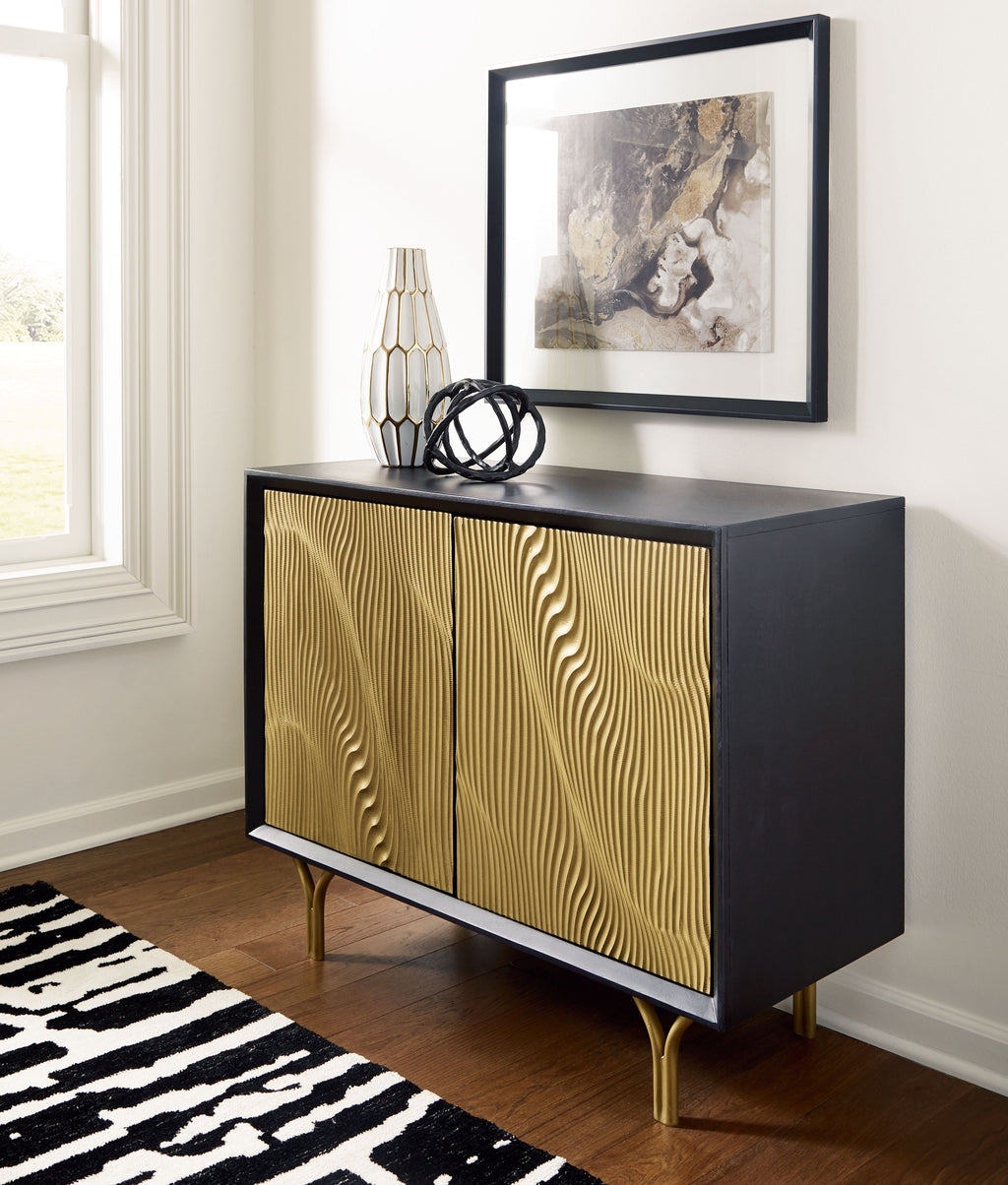 Accent cabinet with gold fluted doors and dark body; vase on top, gold legs