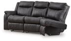 Dark gray reclining loveseat with high back cushions, padded track arms, and footrest
