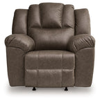 Dark brown rocker recliner chair with button-tufted back, wide armrests, and base