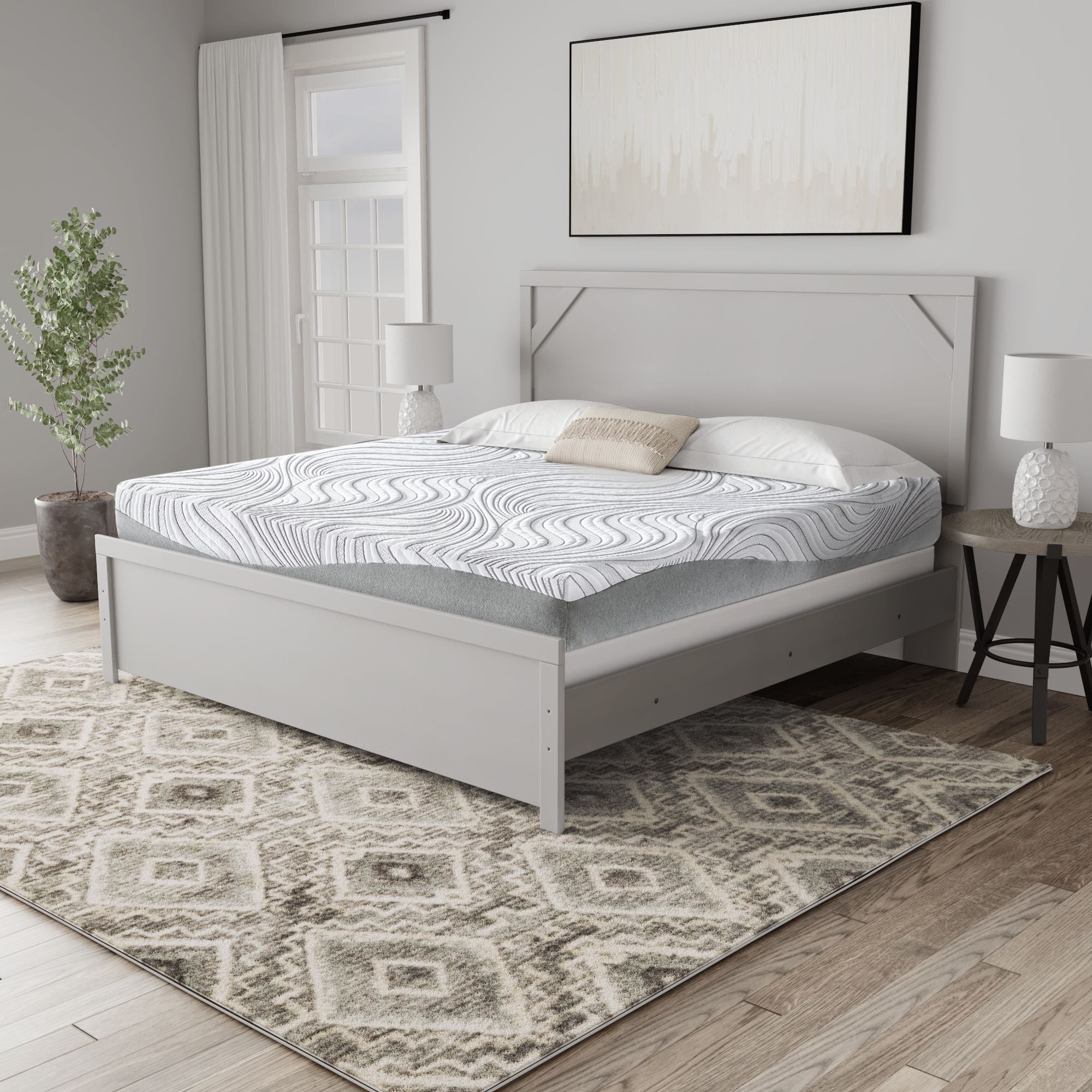 White hybrid mattress with wavy quilted top and gray sides on a bed frame