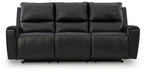Black reclining sofa with tufted backrest and wide padded armrests