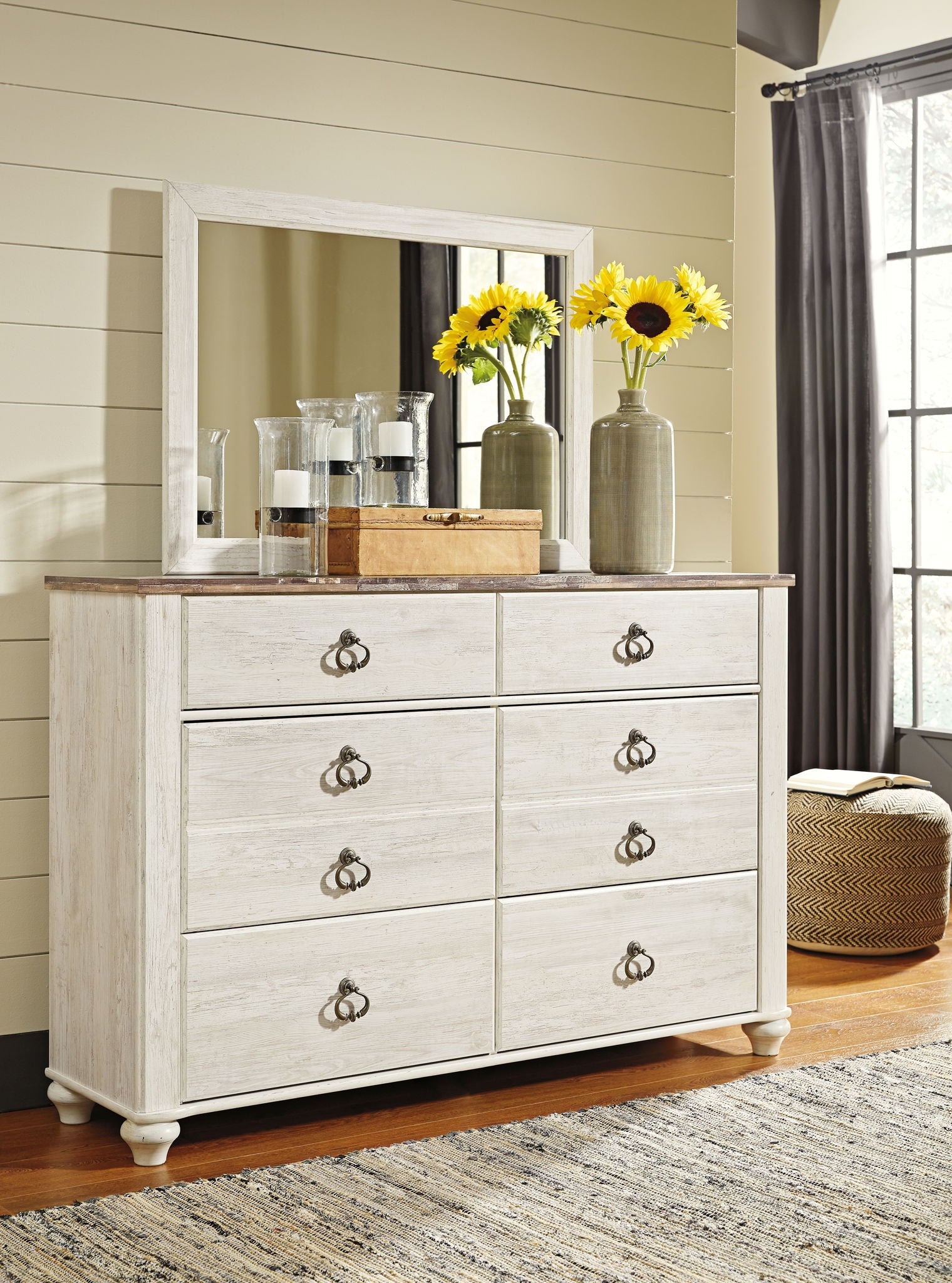 Beige dresser with attached mirror and six drawers, bronze knob pulls