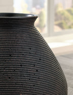 Dark brown ceramic vase with vertical ribbing and flared rim