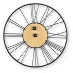Round wall clock with wood face, black metal rim, and four black mounting pieces