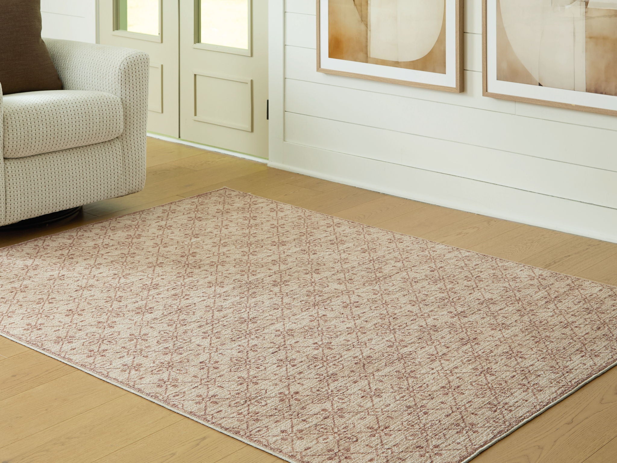 Area rug corner view with repeating red lattice pattern on beige ground