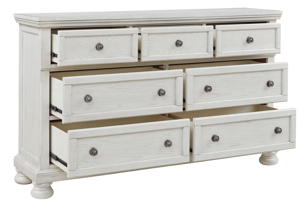 Antique white dresser with seven drawers and round knob pulls, partially opened drawer fronts.