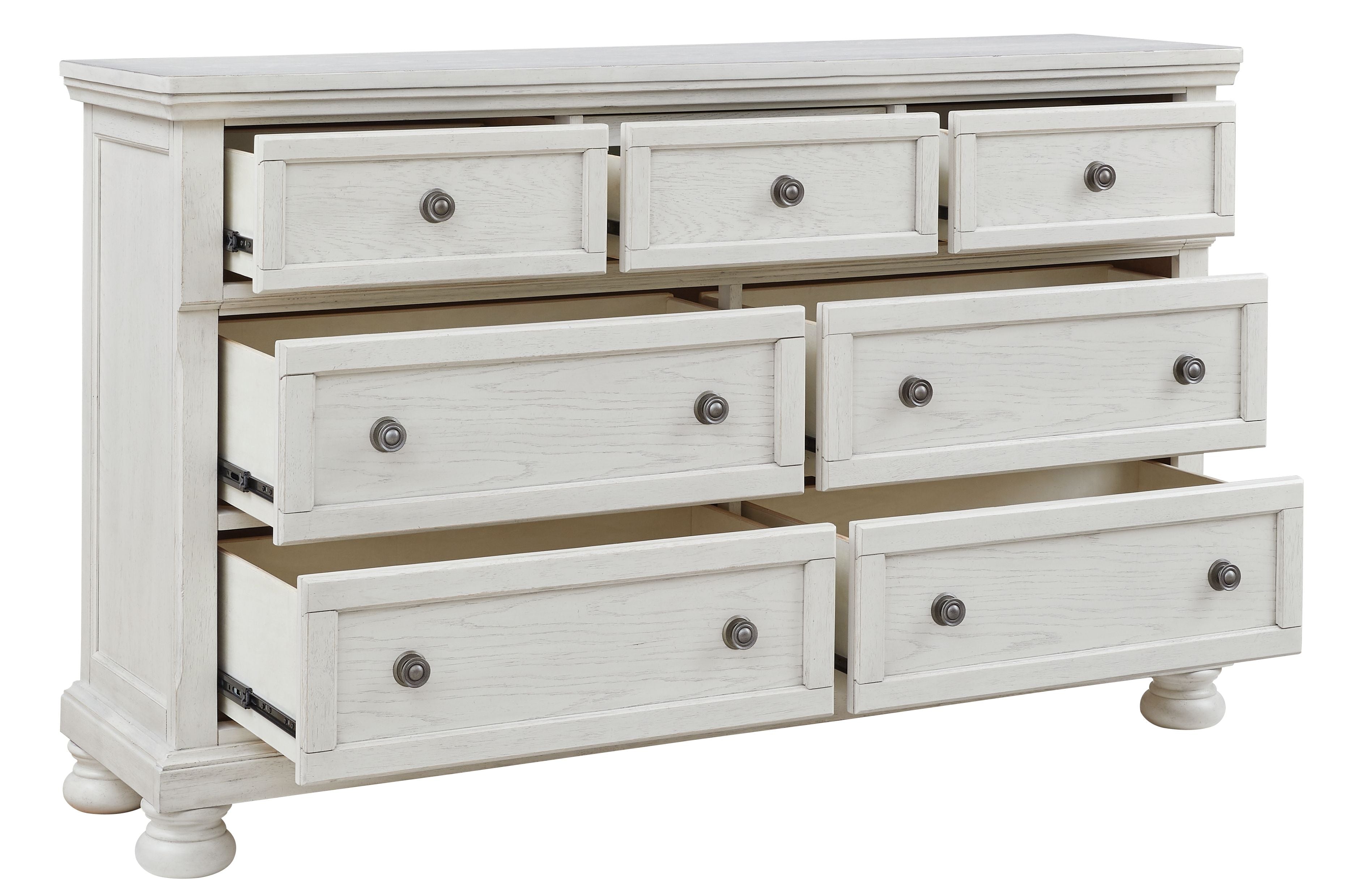 Antique white dresser with seven drawers and round knob pulls, partially opened drawer fronts.