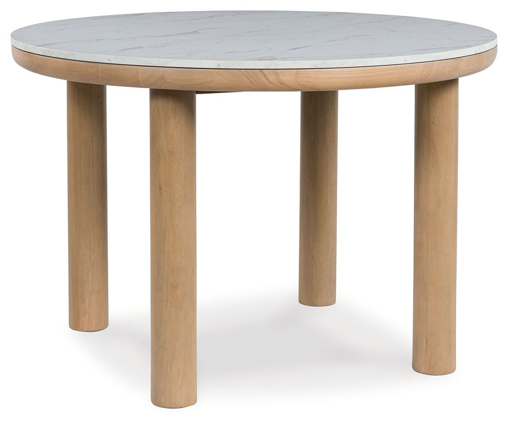 Light brown round dining table with four tapered legs and light gray marble-look top