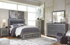 Gray storage bed with drawers, dresser, and mirror in bedroom set