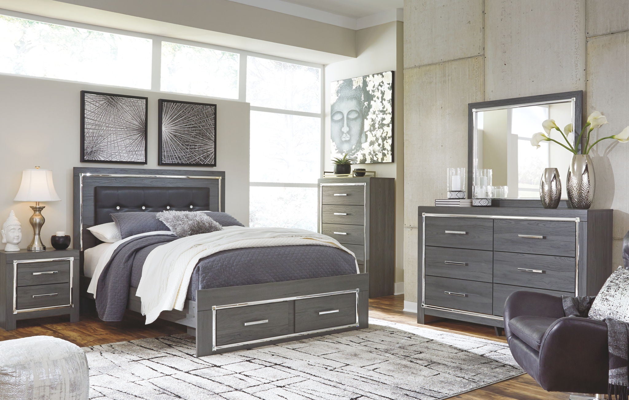 Gray panel bed with dark upholstered headboard and storage drawers, neatly styled bedding